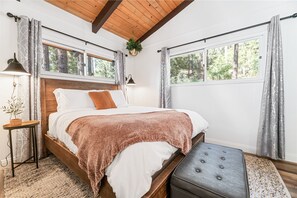 Spacious master bedroom with its own sink! Lay in bed and let the mountain views inspire you to relax in the cabin or head out on a hike...