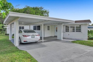 This house has a carport. It will keep you dry on rainy days. 