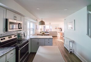 Updated kitchen with stainless appliances and stone countertops (A)