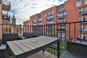 The balcony's stylish design complements the apartment's decor. 