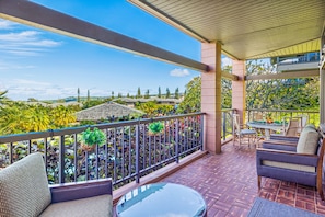 Spacious covered lanai area with lounging furniture