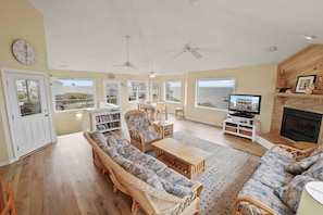 Starting at the top, enjoy the bright and roomy upper-level great room with walls of windows as a place to kick back and relax.