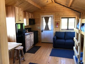 View of main room from bedroom.  Couch pulls out into twin bed.