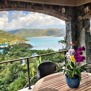 Eat your breakfast and watch sailboats move in and out of Coral Bay Harbor.