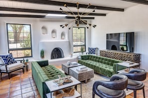 Stunning living room with plenty of seating, gas fireplace and smart tv.