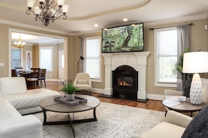 Enjoy the atmospheric glow of the Living Room's gas fireplace while logged into your favorite streaming apps on a 65” Roku HDTV.