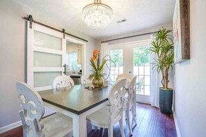 Dining room table. Seats 6 comfortably. Barn door opens into kitchen. 