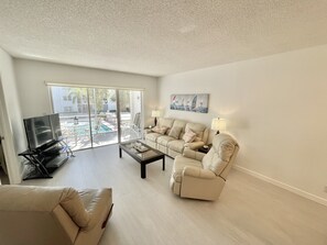 Bright, spacious living room with cable television and Wi-Fi. 