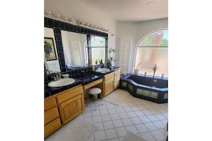Master bath, jacuzzi, shower, toilet, and two sinks. 