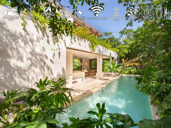 Impressive pool with a unique design surrounded by natural vegetation.