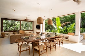 Spacious dining area connected to the living room. Designed in natural tones with large windows that connect to the exterior.