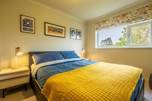 12 The Close, Brancaster Staithe: Master bedroom with colourful artworks