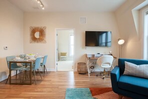Zoomed out showing the dining area, entry to the bedroom and dedicated workspace