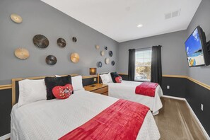Spacious guest room with 2 double beds and television