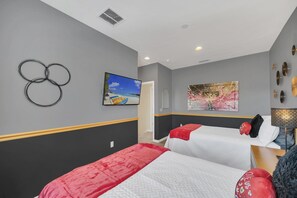 Spacious guest room with 2 double beds and televison