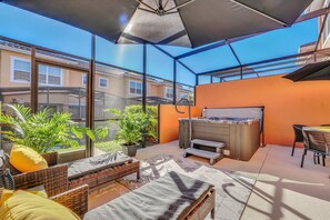 Private covered lanai with hot tub, lounge area and dining area