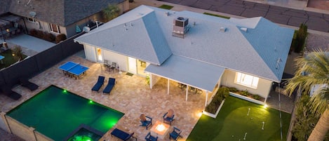 A truly resort-style backyard w/ heated pool, spa, firepit, golf, games & grill