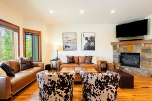 Main Level Great Room with a Gas Fireplace and Hardwood Flooring