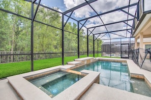 Screened backyard with heated pool and spa