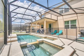 Screened backyard with heated pool and spa, BBQ, dinning table and lounge chairs