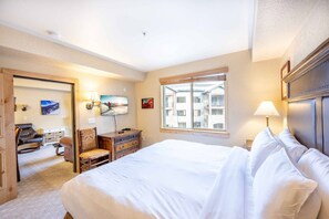 The primary bedroom is located off of the living room with a Flat Screen TV