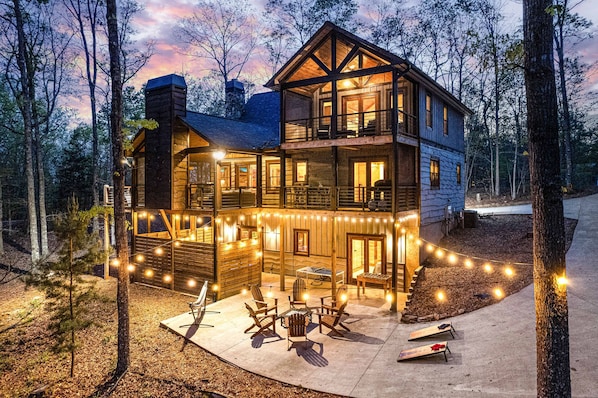 This exclusive home features upscale amenities and outdoor entertainment, in a natural wooded setting