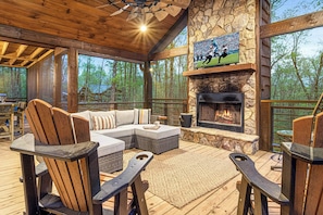 Gather around for the ultimate outdoor experience! Enjoy the warmth of the stone fireplace, watch your favorite game on the big screen, a rocking swing, and take in the serene forest views from the comfort of our spacious screened-in porch. Perfect for coz