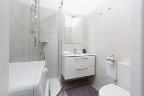 The bathroom's stylish design provides a comfortable and functional space. 
