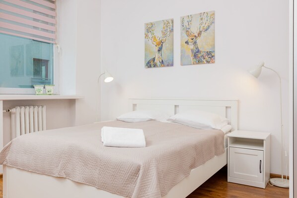 Relax in the stylish living area with a comfortable bed and modern decor.