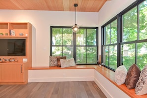 The large windows brings in natural light that flows throughout the house.