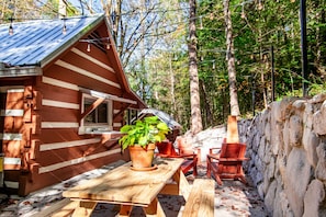 Enjoy outdoor dining at the wooden picnic table surrounded by the natural beauty of the forest.