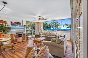 Tropical ocean view from living room with flat screen HD TV and tropical decor 