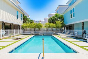 The community pool is steps from the home