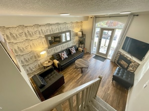 Fireplace and TV in the living room. Walk outside to your patio with a view of the mountains.