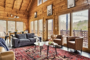Cozy living room with Cathedral ceiling, gas fireplace and wooded views.