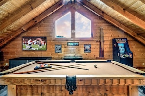 Game room with Pool table, Foosball, Arcade Machines, board games & TV