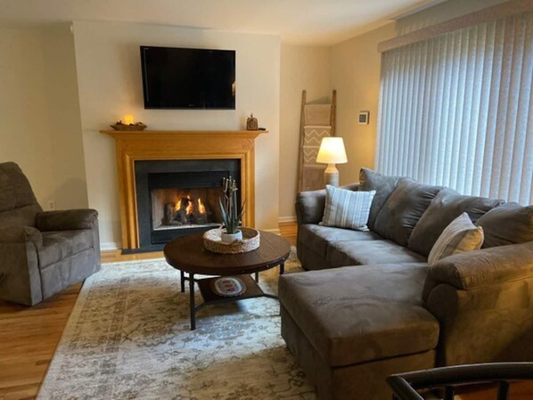 Relax & enjoy a view of the sunset from the couch that looks out a large window.