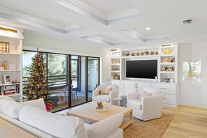 Oversized LED smart TV in the living area, perfect for relaxing after a long day at the beach