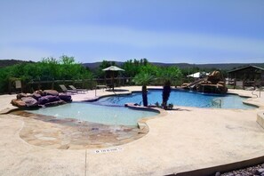 resort style pool with beach entry and slide