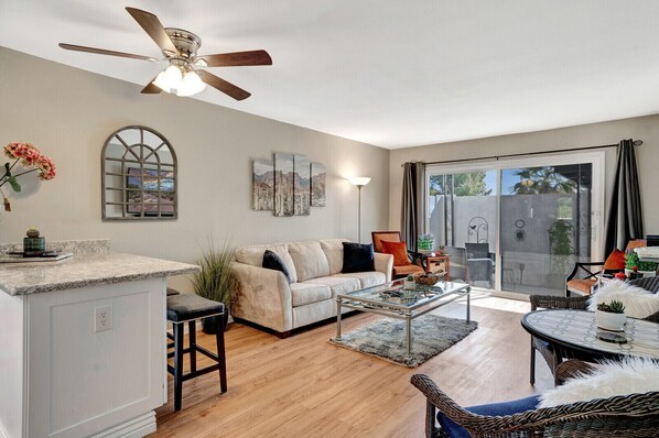 Living room and dining areas, sliding door to a private patio.