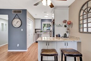 Dining area with a fan & light remote control, kitchen with a sunlight tube.