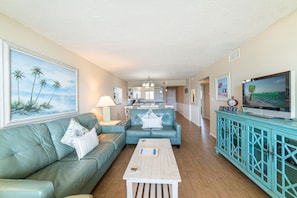 The living room features a queen sized sofa sleeper, matching loveseat, and coordinated recliner