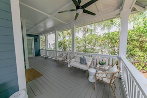 Large wrap around porch to sit and relax after a long day at the beach