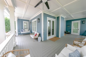 Large wrap around porch to sit and relax after a long day at the beach