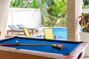 Pool table located in front of the pool!