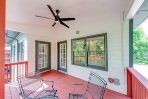 Enjoy some porch sitting by the river Nice sitting/dining area with ceiling fan.