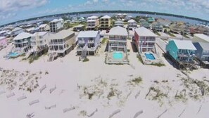 House from sky. Water you see 2 streets over is the lagoon. Beach by house 