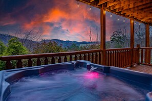 Relax in the hot tub and take in the mountain scenery.