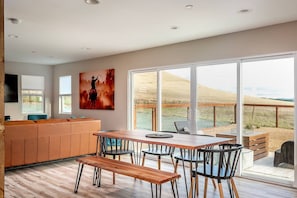 Savor every moment at our newly built vacation rental dining room, featuring a stunning live edge table with comfortable seating for six, perfectly positioned in front of double sliders that offer unobstructed views of the picturesque Edna Valley. Enjoy a