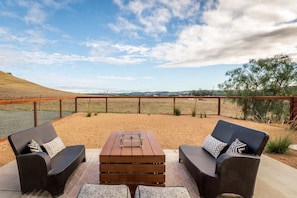 Escape to a serene outdoor haven at our newly built vacation rental backyard, where you can relax around the firepit and take in the breathtaking views of Edna Valley's rolling hills. With ample seating for six on cozy couches and drought-tolerant landsca